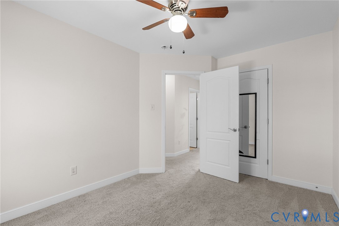 2110 Chaucer Court Aylett, VA 23009 - Photo 32 of 40 an empty room with closet and a chandelier fan
