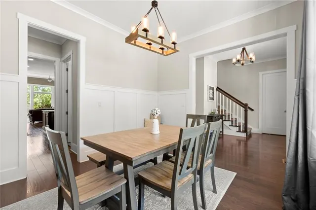 a kitchen with stainless steel appliances a sink a stove a refrigerator cabinets and wooden floor