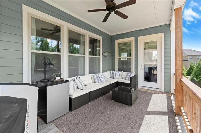 a living room with furniture a flat screen tv and a window