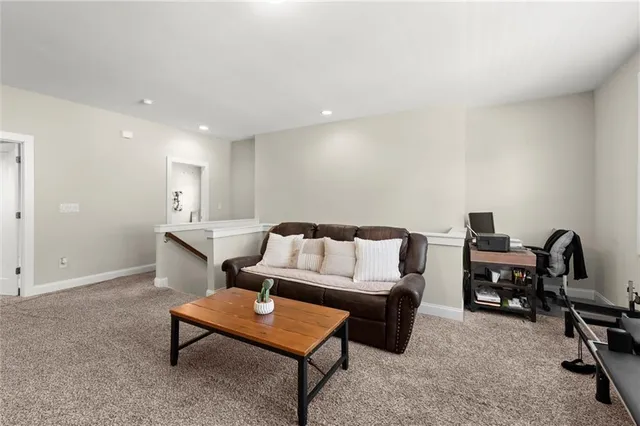 a bedroom with a bed a desk and chair with the bookshelf