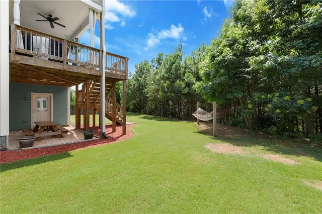 an aerial view of residential houses with outdoor space and trees