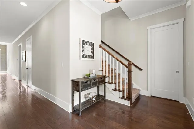 a view of a hallway with wooden floor and windows