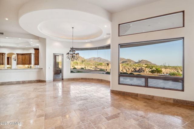a view of an empty room with a ceiling fan