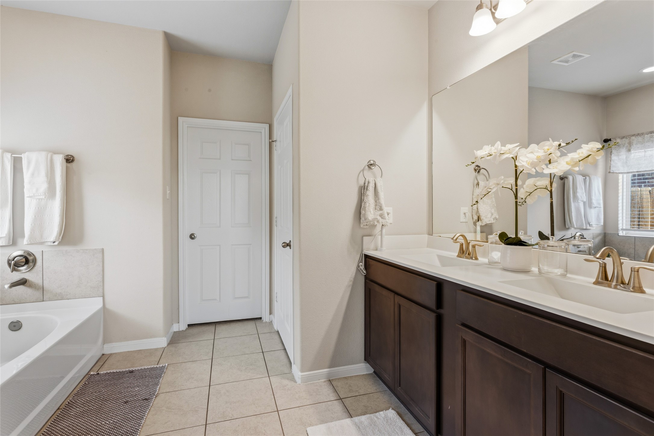 7254 Victorville Drive Rosharon, TX 77583 - Photo 10 of 27 a spacious bathroom with a double vanity sink a mirror and a bathtub