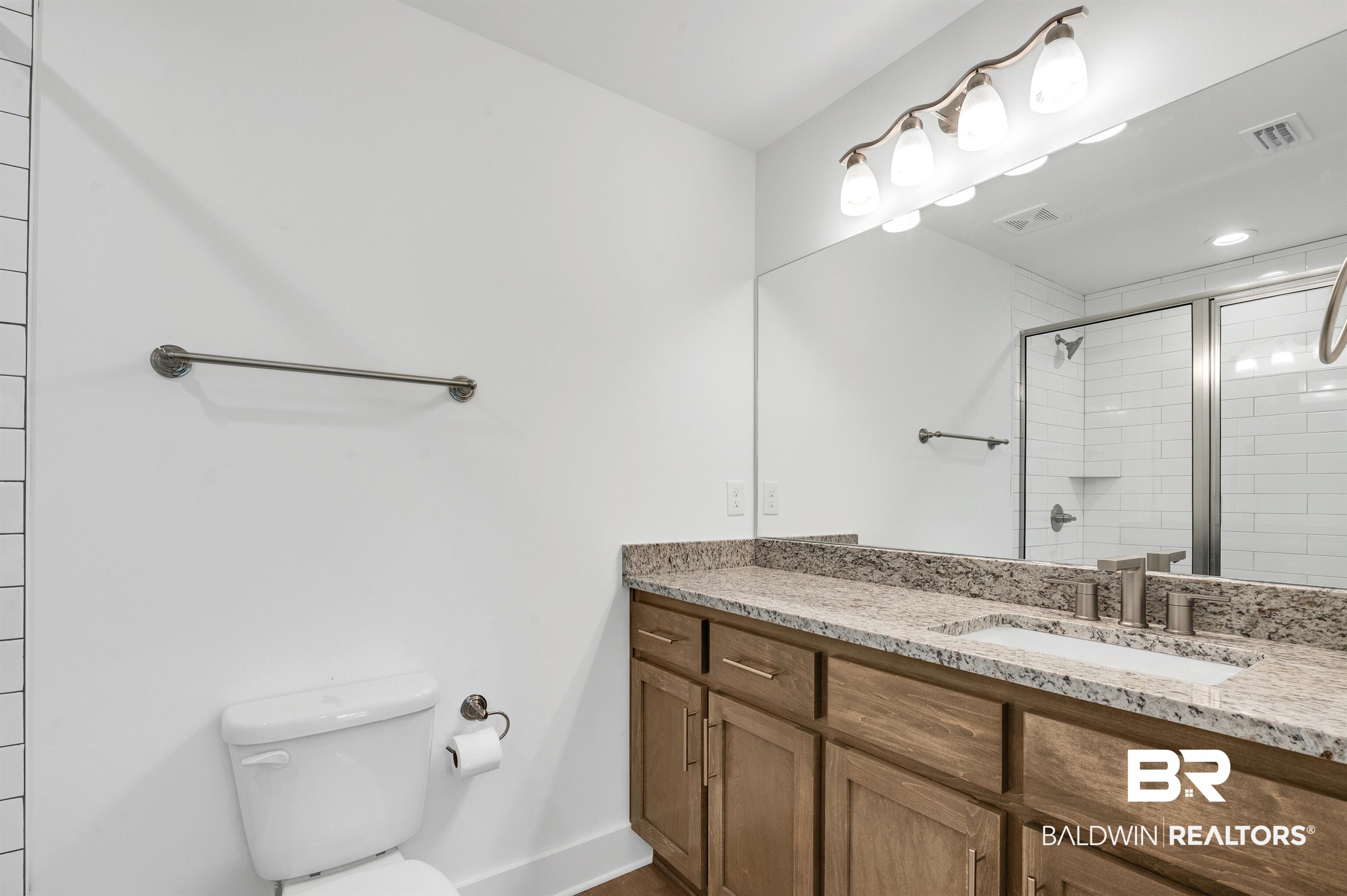 22045 8th Street Silverhill, AL 36576 - Photo 26 of 39 Full bath with toilet, vanity, a stall shower, and baseboards