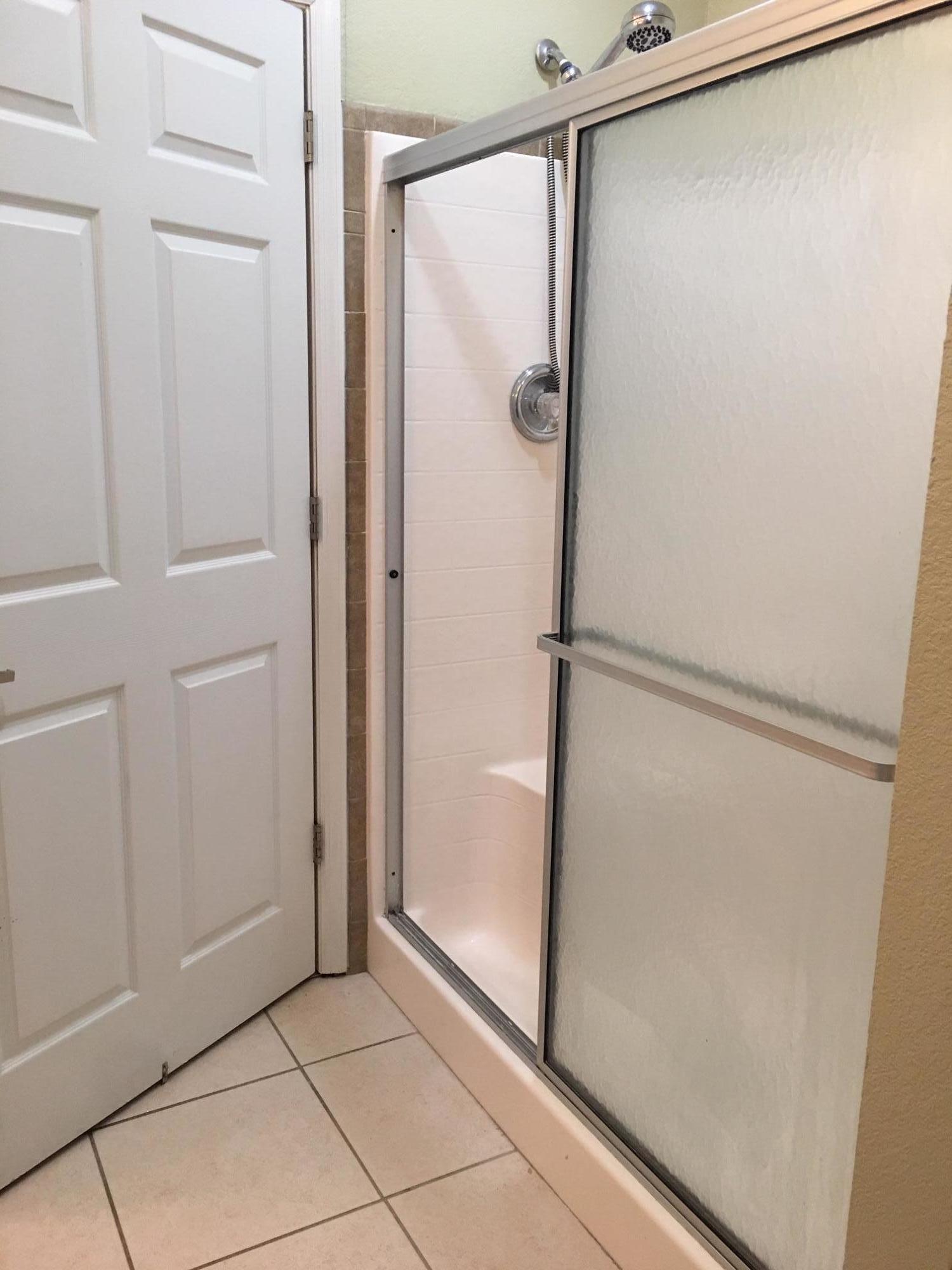 47 Central 7th Street Santa Rosa Beach, FL 32459 - Photo 10 of 19 a bathroom with a glass shower door