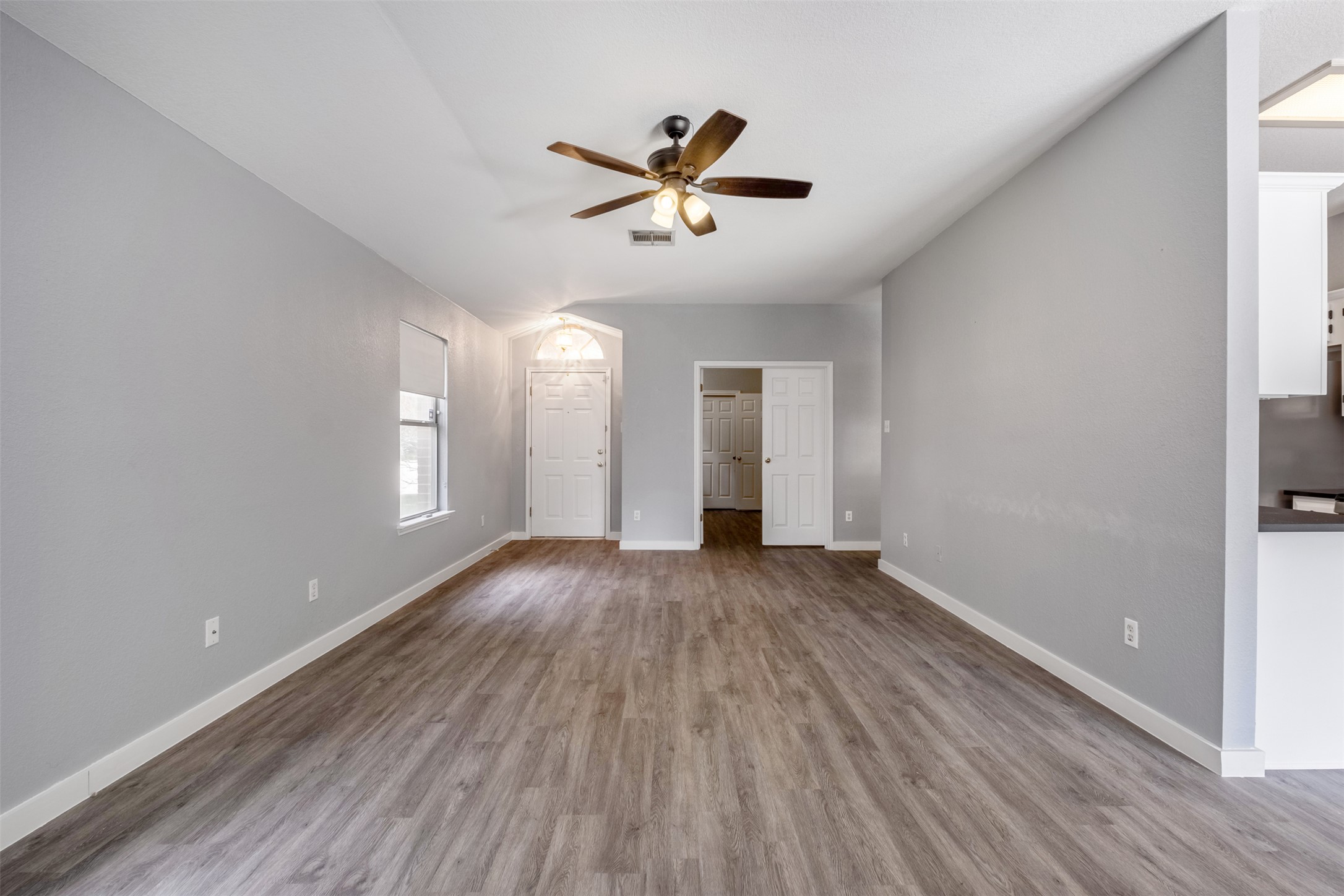 3413 Ruby Red Drive Austin, TX 78728 - Photo 5 of 19 A spacious common area boasts wood-look flooring and an overhead ceiling fan for comfort.