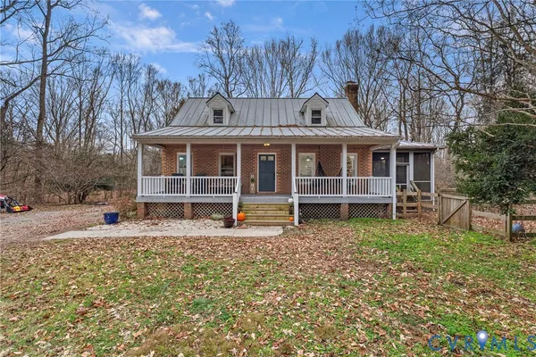 a view of a house with a yard and sitting area