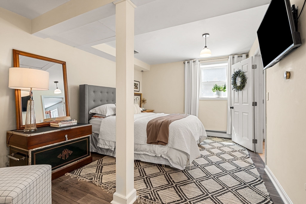 19 Powhatan Road Pepperell, MA 01463 - Photo 30 of 38 a bedroom with a bed and a flat screen tv