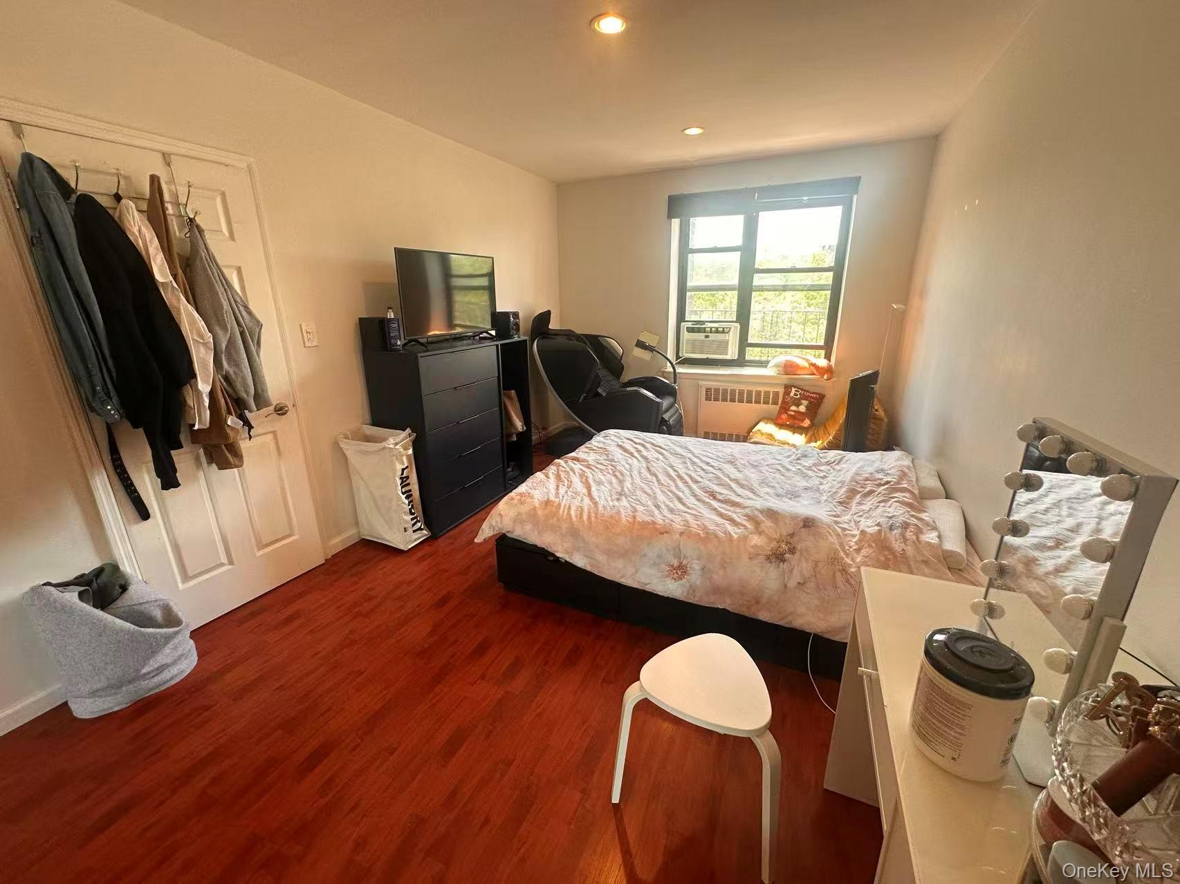 139-15 28th Road, Unit 6G Queens, NY 11354 - Photo 16 of 20 a bedroom with furniture and a window