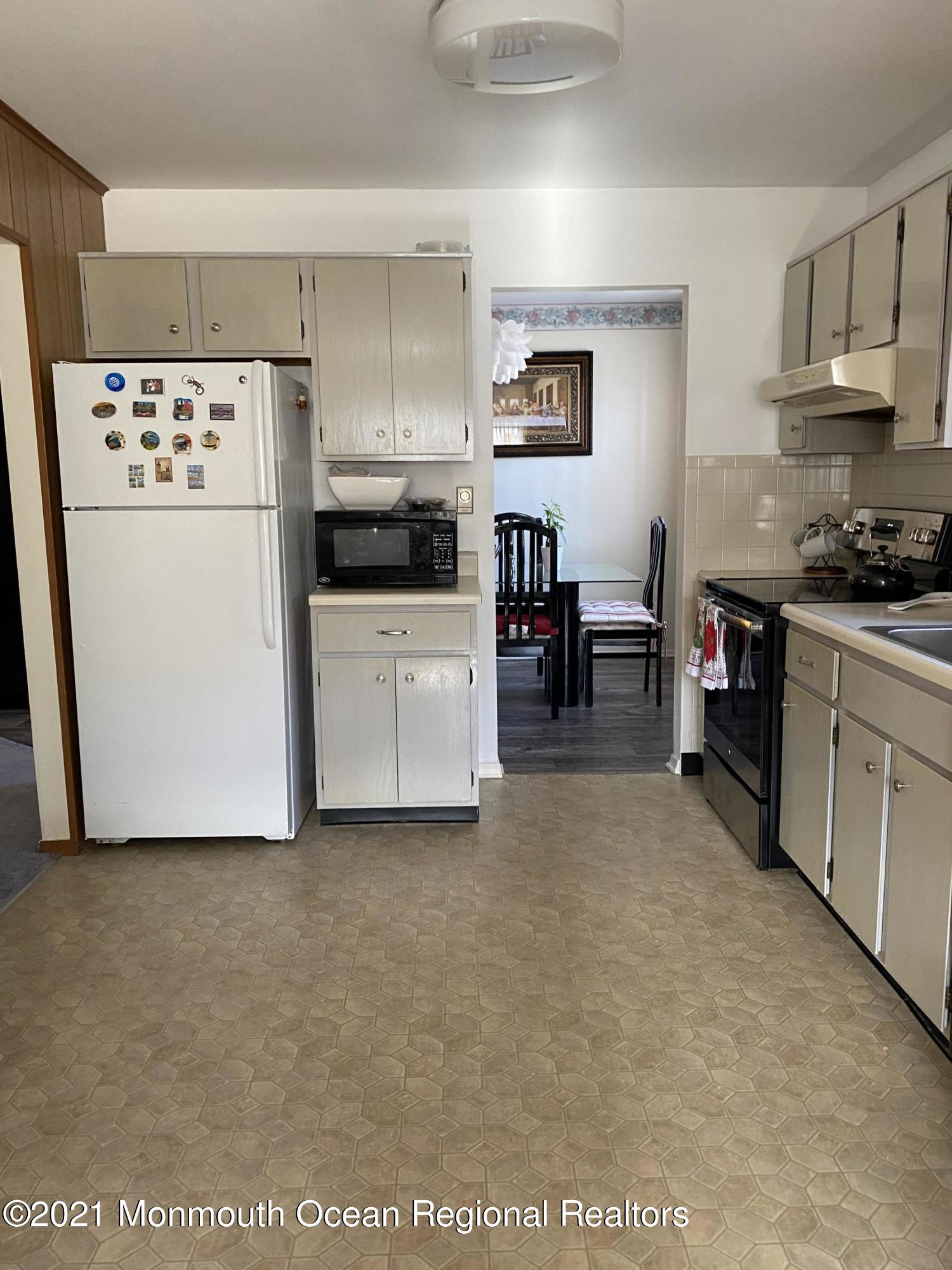 47 Augusta Road, Unit 73 Whiting, NJ 08759 - Photo 5 of 13 a kitchen with cabinets and white appliances