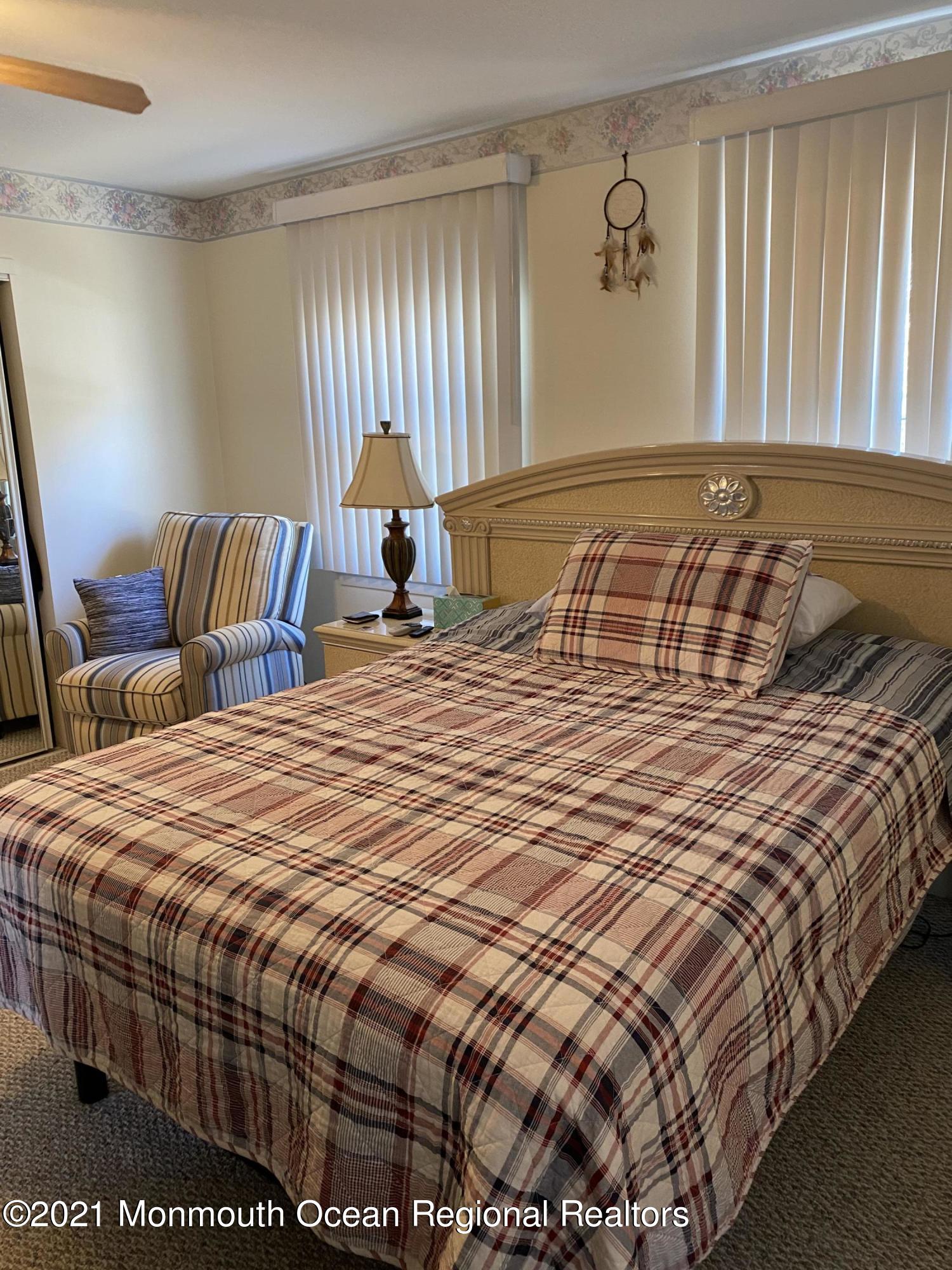 47 Augusta Road, Unit 73 Whiting, NJ 08759 - Photo 6 of 13 a bedroom with a bed and window