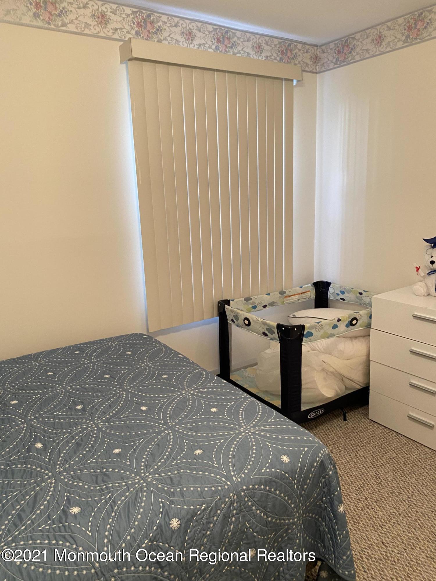 47 Augusta Road, Unit 73 Whiting, NJ 08759 - Photo 8 of 13 a room with a bed and a dresser