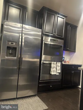 a kitchen with granite countertop stainless steel appliances and wooden cabinets