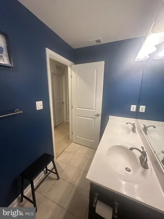 a bathroom with a sink a toilet a mirror and shower curtain