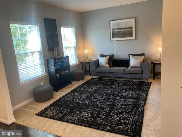 a living room with furniture and a rug