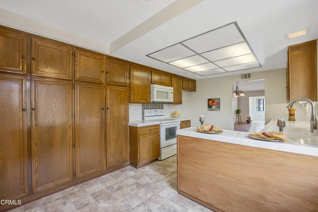 a kitchen with stainless steel appliances granite countertop a sink cabinets and wooden floor