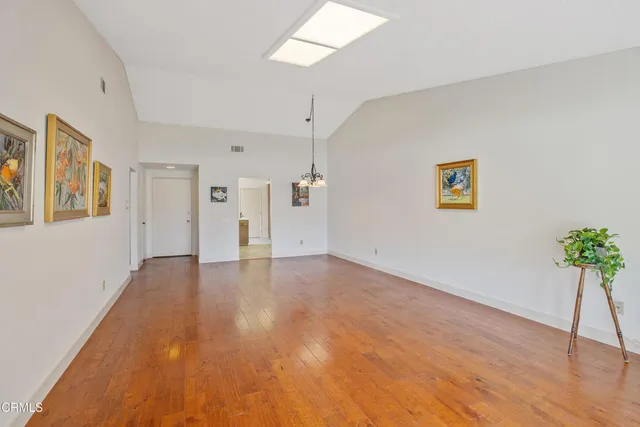 a view of a room with wooden floor and potted plant
