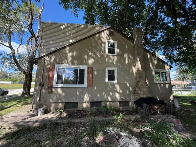 a front view of house with a garden