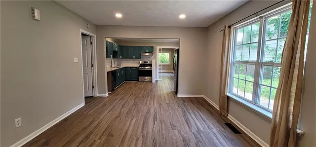 a view of a hallway view with wooden floor and furniture