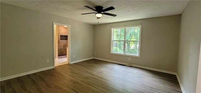 a view of a livingroom with a hardwood floor and a ceiling fan