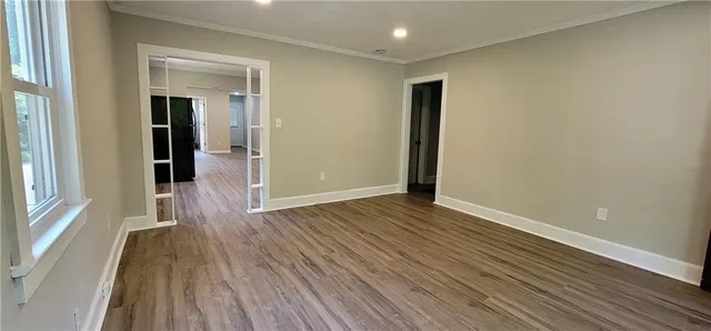 wooden floor in an empty room with a window