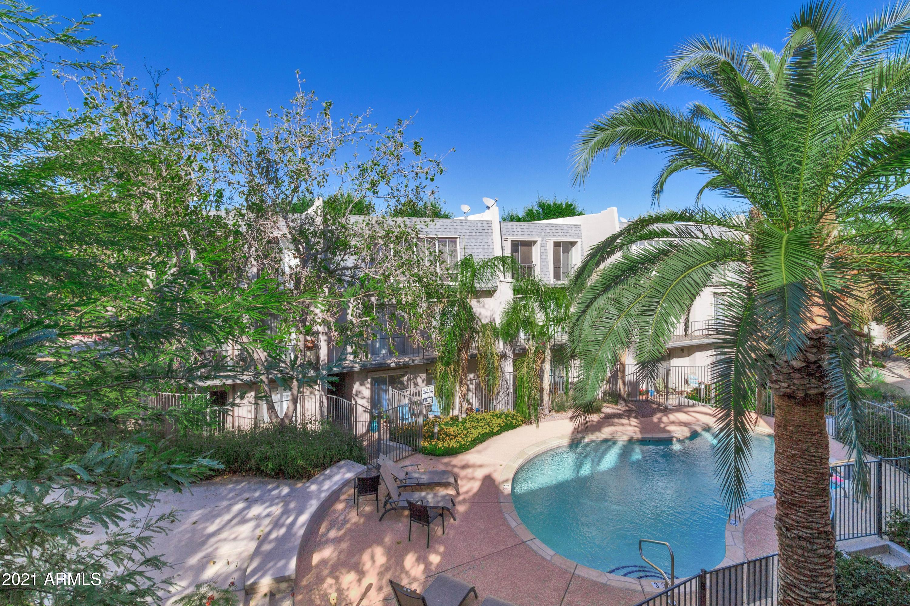 1002 East Osborn Road, Unit C Phoenix, AZ 85014 - Photo 12 of 15 a view of a swimming pool with outdoor seating and plants