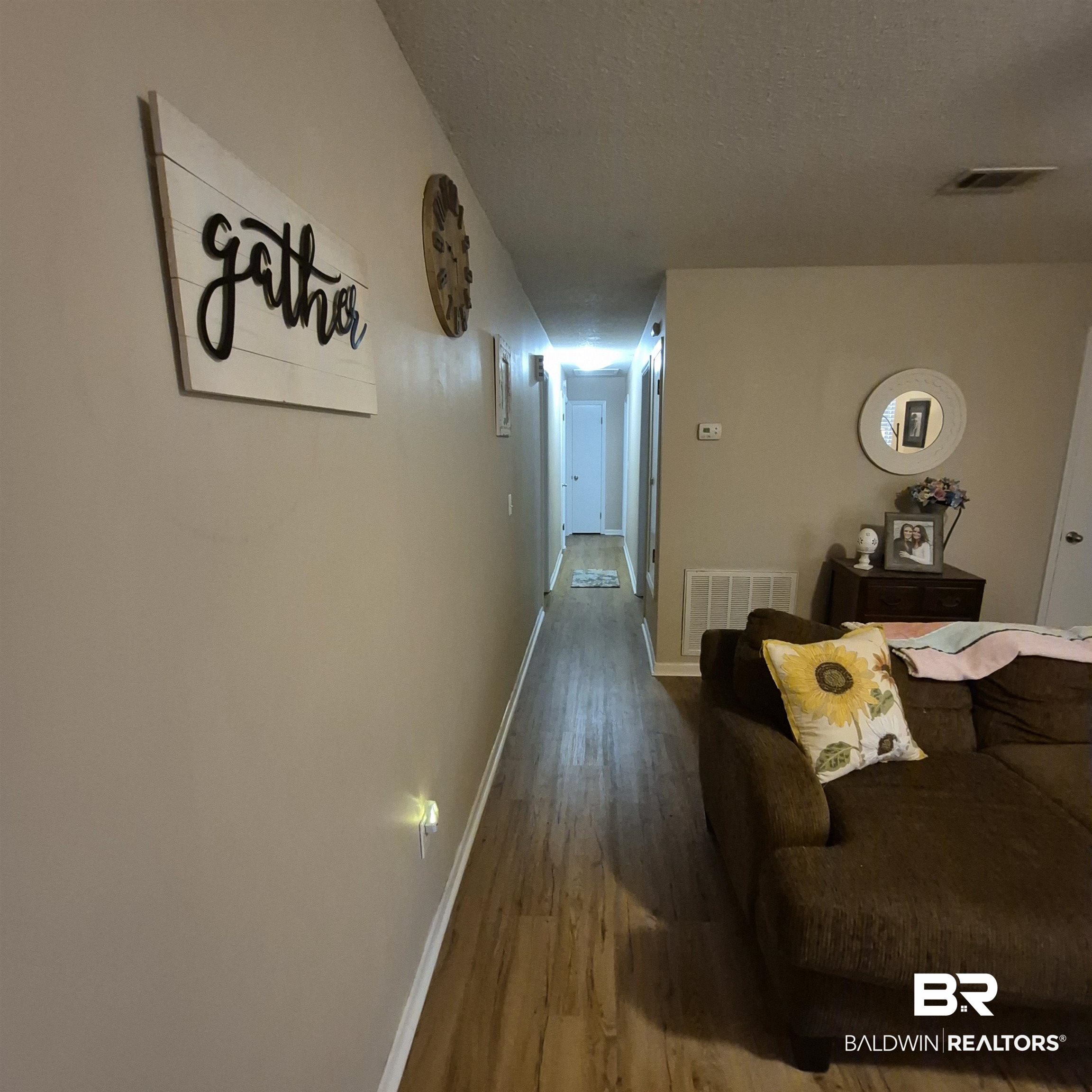 721 Perryman Street Evergreen, AL 36401 - Photo 7 of 26 Hall featuring wood finished floors and a textured ceiling