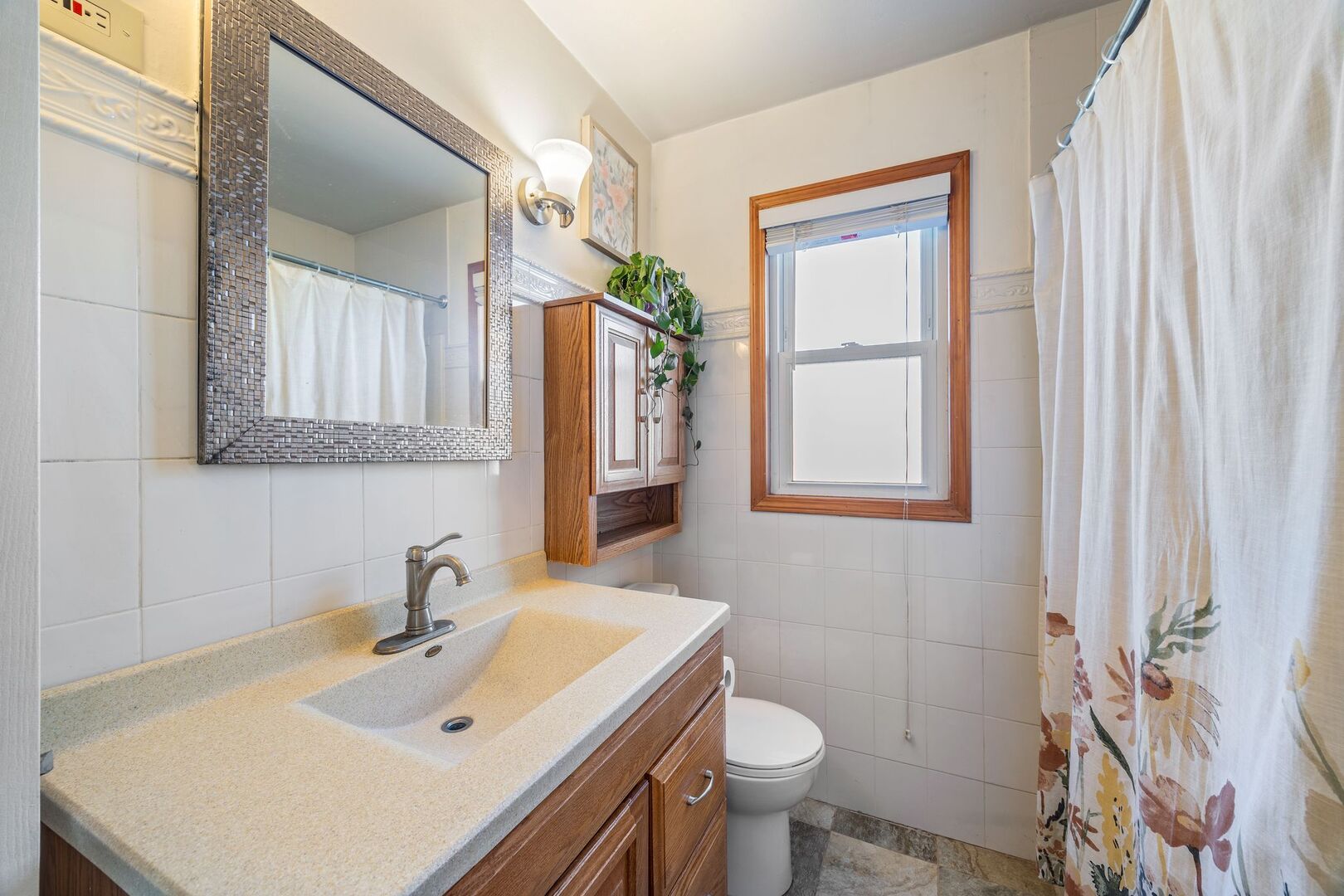 5300 West Foster Avenue Chicago, IL 60630 - Photo 14 of 27 a bathroom with a sink toilet and mirror