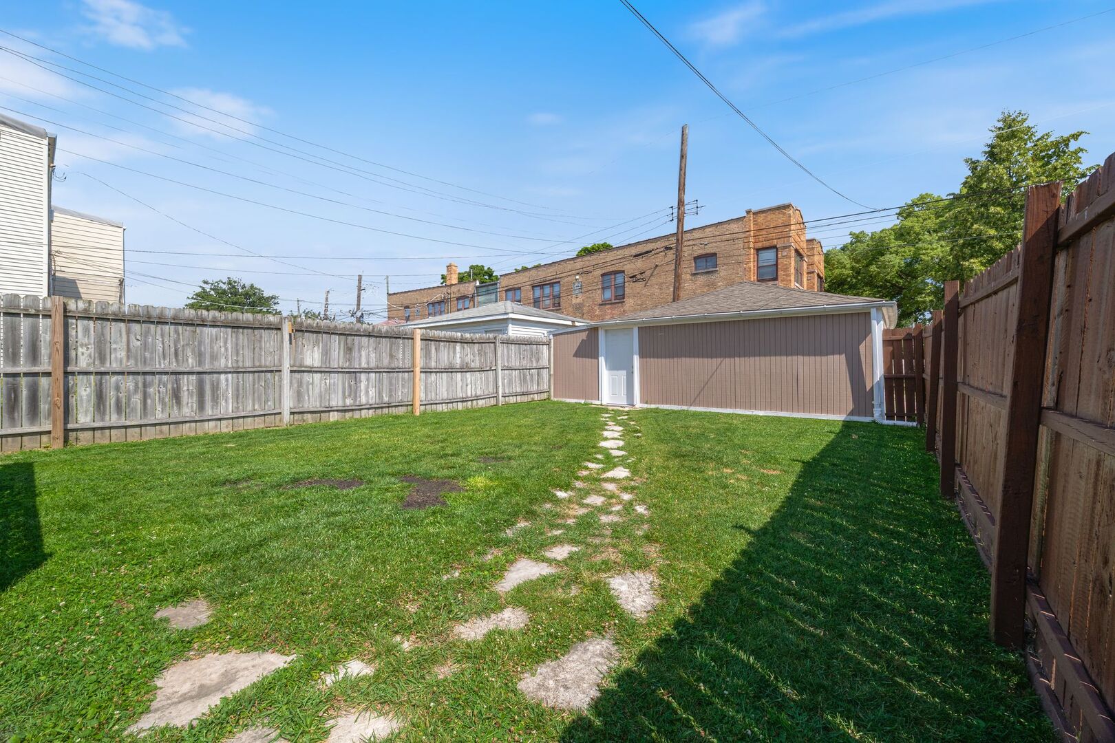 5300 West Foster Avenue Chicago, IL 60630 - Photo 25 of 27 a view of a house with a small yard and sitting area