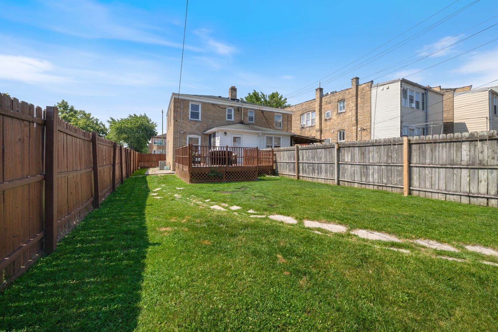 5300 West Foster Avenue Chicago, IL 60630 - Photo 26 of 27 a view of a house with a big yard and large trees
