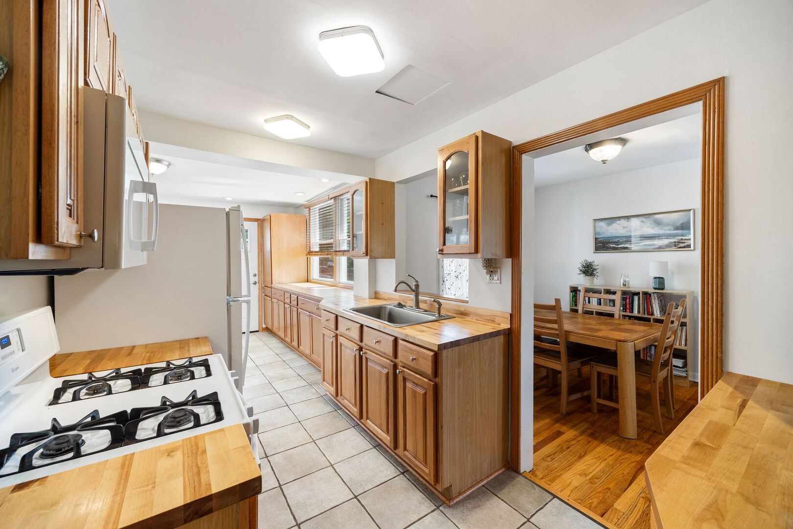 5300 West Foster Avenue Chicago, IL 60630 - Photo 6 of 27 a kitchen with stainless steel appliances granite countertop a stove and a sink