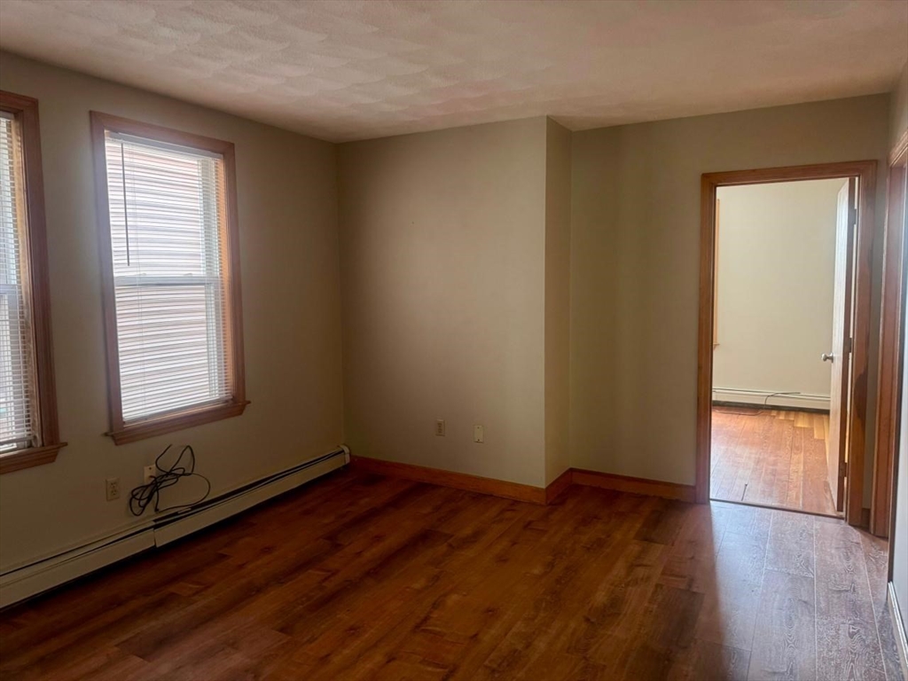 68 Maverick Street Chelsea, MA 02150 - Photo 7 of 16 an empty room with wooden floor and windows