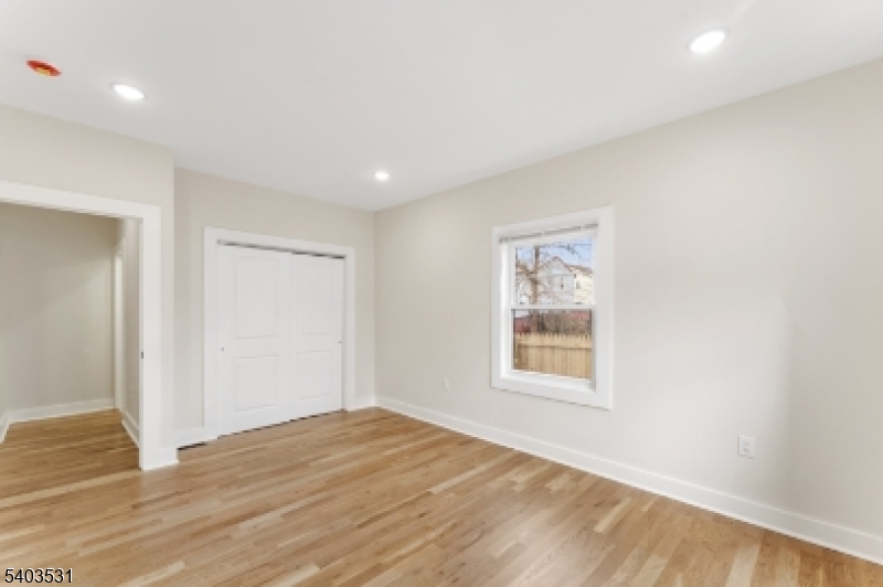 306 Carnegie Place Union, NJ 07088 - Photo 11 of 23 a view of a big room with wooden floor and windows
