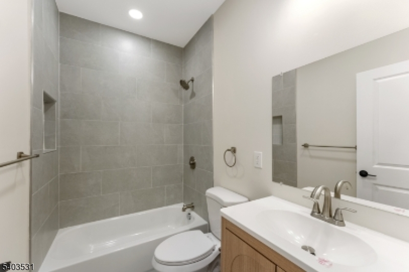 306 Carnegie Place Union, NJ 07088 - Photo 14 of 23 a bathroom with a sink a toilet and shower