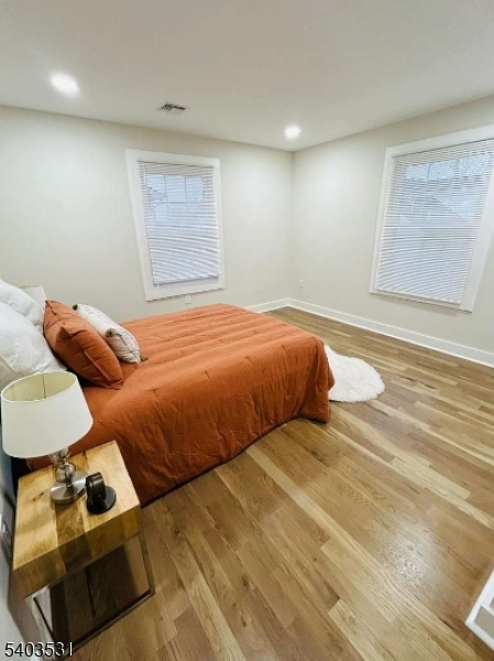 306 Carnegie Place Union, NJ 07088 - Photo 16 of 23 a bedroom with a bed and wooden floor