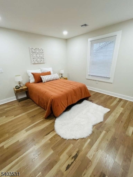 306 Carnegie Place Union, NJ 07088 - Photo 17 of 23 a bedroom with a bed and a night stand