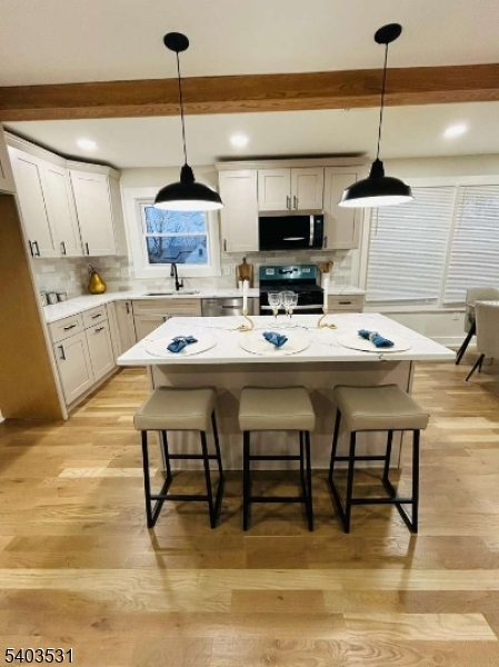 306 Carnegie Place Union, NJ 07088 - Photo 4 of 23 a kitchen with stainless steel appliances kitchen island granite countertop a dining table and chairs