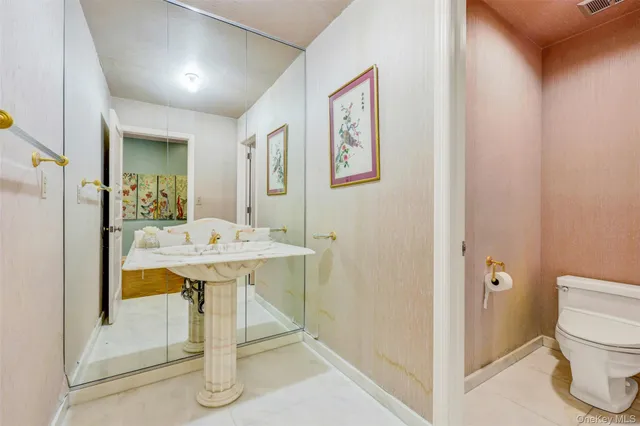a view of an empty room with window and a kitchen