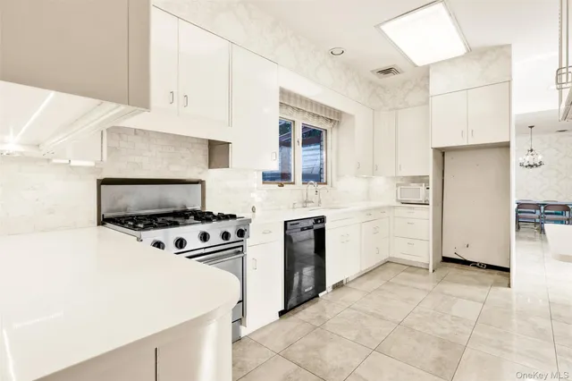 a bedroom with a bed couch and a large window
