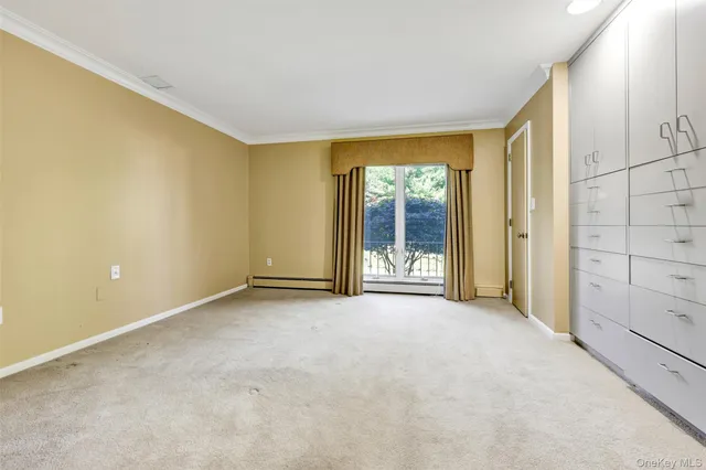 a spacious bedroom with a bed and a chair