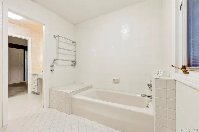 a bedroom with a bed and a large mirror