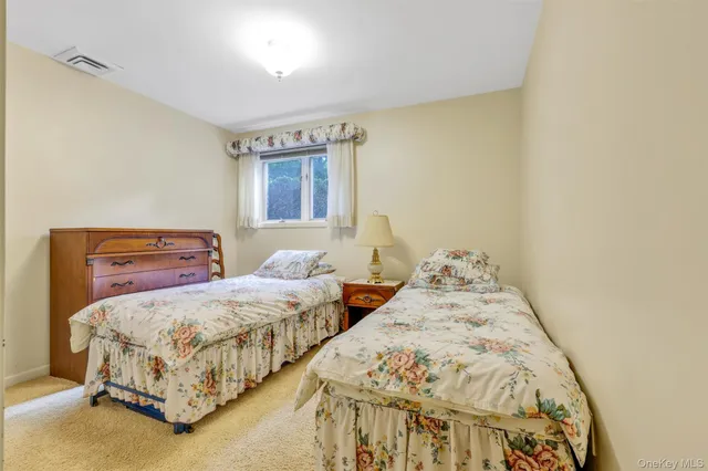 a bed room with a bed and a chair