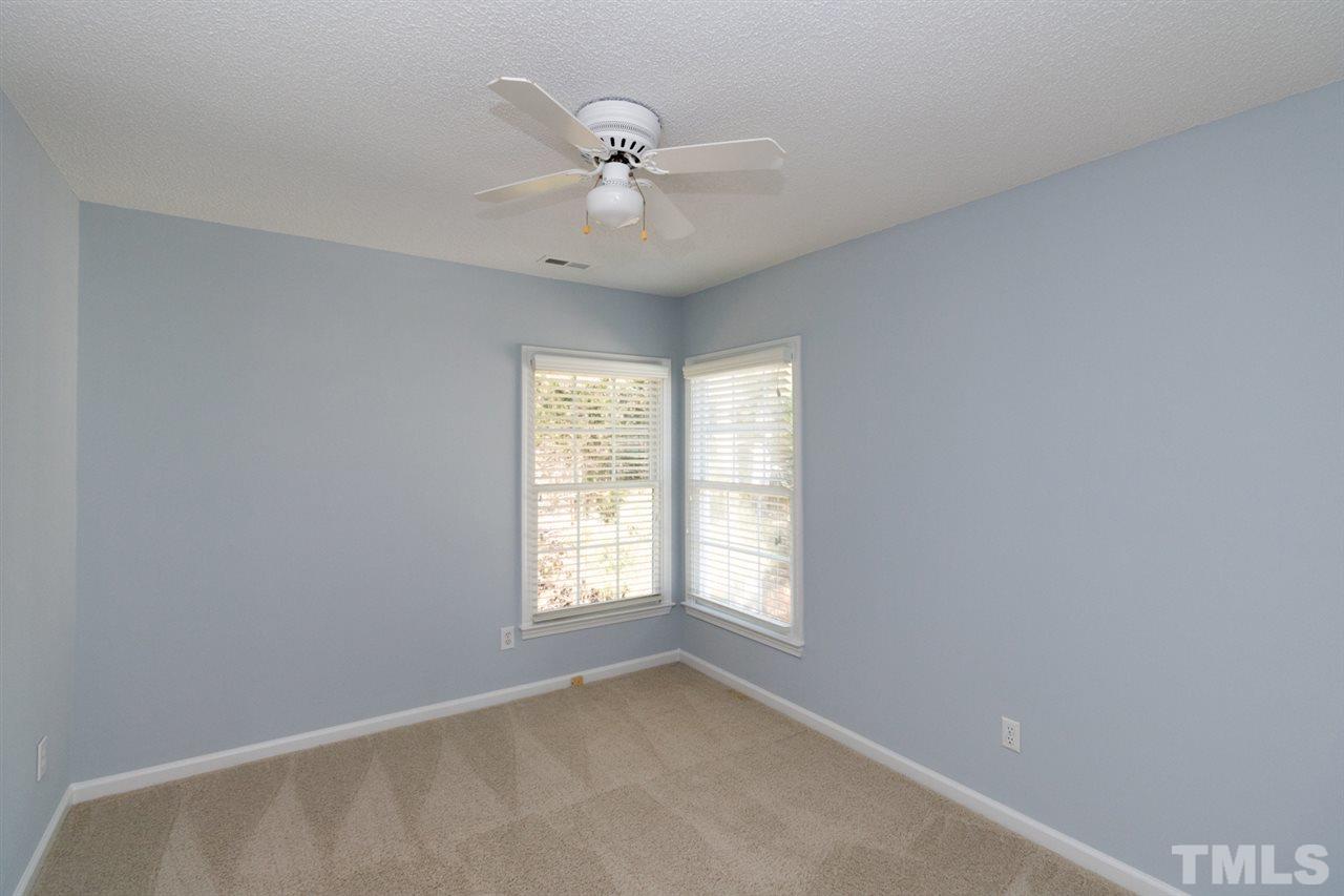 9105 Breeland Way Raleigh, NC 27613 - Photo 22 of 25 an empty room with windows and fan