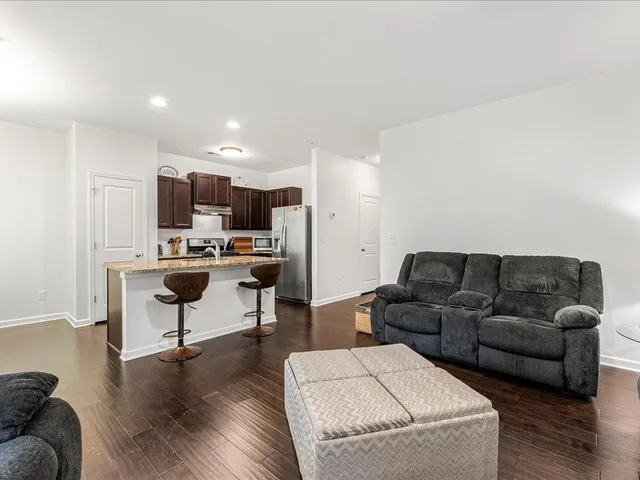 a living room with furniture and a wooden floor