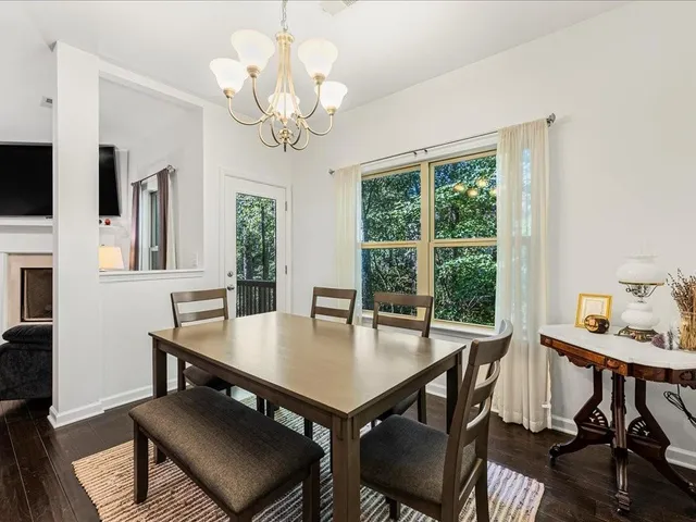 a view of a dining room with furniture and a chandelier