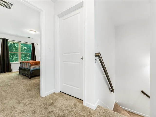 a view of front door and bedroom with furniture