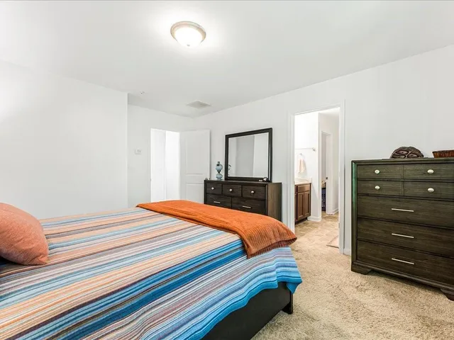 a bedroom with a bed and a dresser