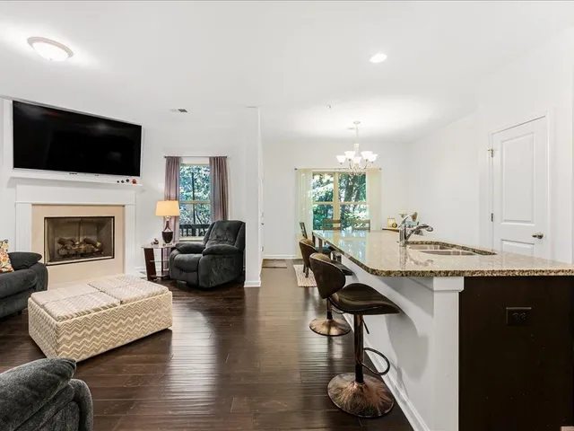a living room with furniture fireplace and flat screen tv