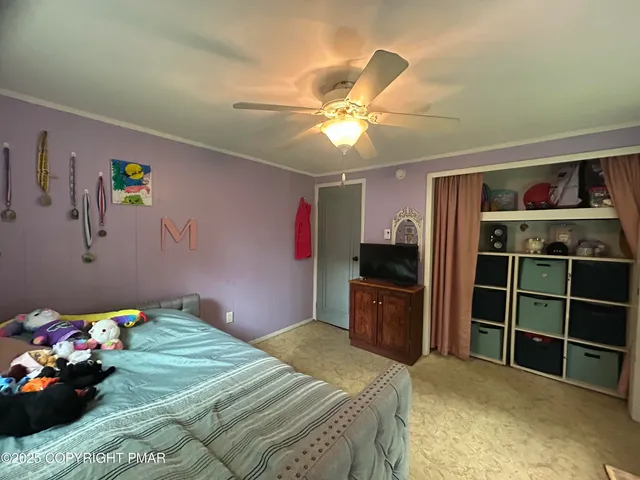a bedroom with a bed and a television